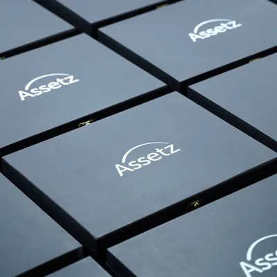 Your brand, front and center. Here are some custom wooden boxes I created for Assetz, featuring their logo prominently. This is a great way to make a lasting impression with your corporate gifts.