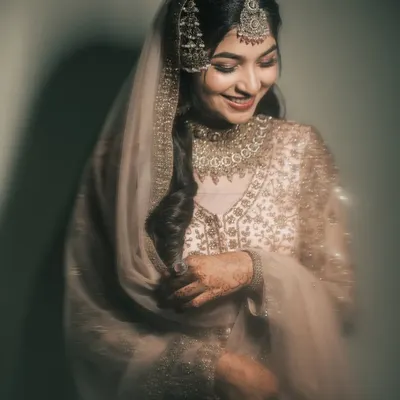 A quiet moment of reflection for the bride. The soft, directional light and her gentle smile create a portrait that is full of grace and emotion, highlighting the beauty of anticipation.