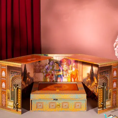 This is a truly divine invitation box that opens up to reveal a sacred scene. It is designed as a small temple or 'mandir', creating a deeply spiritual and memorable unboxing experience for a wedding announcement.