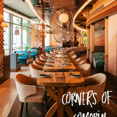 An establishing shot showcasing the beautiful interiors of Comorin. We capture the long tables, unique light fixtures, and elegant design to give potential diners a feel for the restaurant's sophisticated atmosphere.