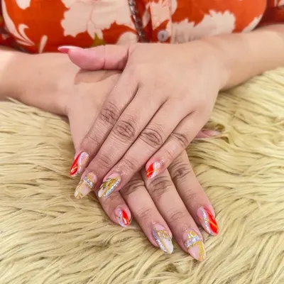 A stunning set of bridal nails designed to make a statement. This look features a mix of sheer nude, bold red, and sparkling silver glitter, with delicate gold leaf details for an extra touch of luxury.
