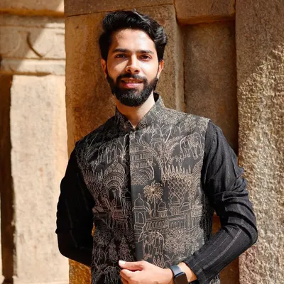 A modern interpretation of traditional thread work. This black Nehru jacket features intricate prints inspired by Indian architecture and motifs, layered over a classic black kurta.