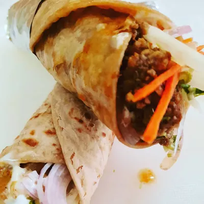 The Bombay Chicken Kheema Roll is a tribute to the flavors of old Bombay. The minced chicken filling is subtly spiced with cinnamon and clove, balanced with fresh vegetables, and wrapped in a flaky paratha.