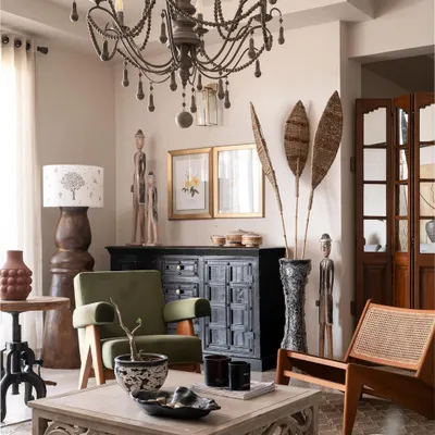 This living room embodies the Wabi-Sabi philosophy, filled with pieces that have a story. We mixed a vintage-style chandelier with tribal art and rustic wooden furniture to create a space that feels collected and personal.
