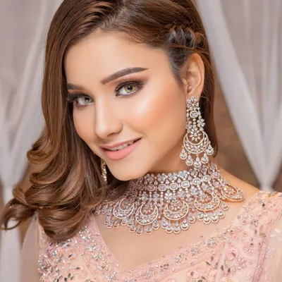 A stunning example of our modern jewellery collection. This rose gold plated diamond-look choker and matching earrings are perfect for receptions, cocktail parties, or any contemporary ethnic look.