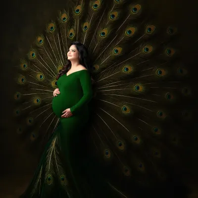 We believe motherhood is a majestic journey. This portrait, featuring an expectant mother in a custom green gown with a dramatic peacock feather train, is one of our signature artistic concepts. We use creative props and lighting to craft powerful, unforgettable images that celebrate this special time.
