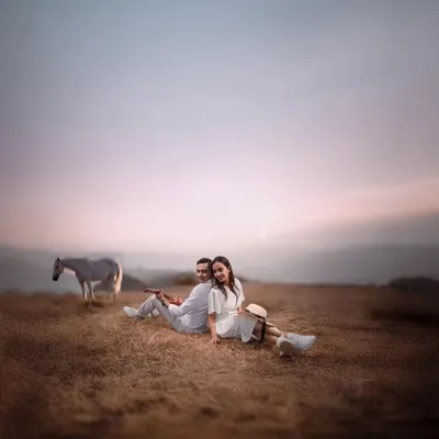 I believe every love story deserves a grand canvas. For Atul and Rachita, we found this serene pasture at dusk, creating a moment that feels like a painting. The quiet presence of the horse adds a touch of magic to their peaceful embrace.