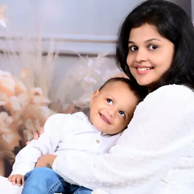 The pure joy on this little boy's face as he snuggles with his mom says it all. This studio portrait captures the warmth and comfort of a mother's embrace in a simple, beautiful way.