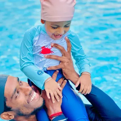 A moment of pure fun and connection between a coach and a young student. Our lessons for toddlers are designed to be engaging and build trust from the very first splash.