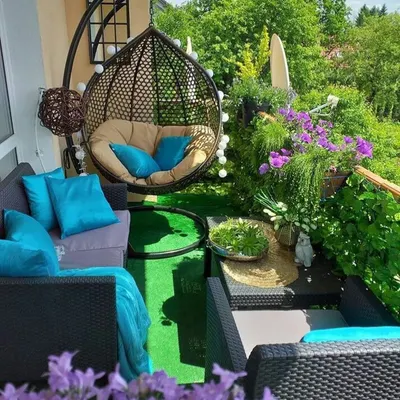 A perfect example of a cozy and vibrant balcony garden. We used a mix of comfortable seating, a hanging swing chair, and an abundance of flowering plants to create a lush, colorful escape.