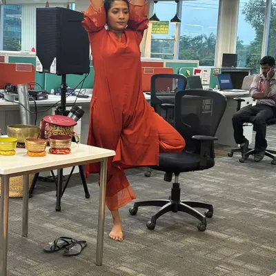Here I am at MagicBricks demonstrating a modified Tree Pose using an office chair for support. This shows how we can adapt classic yoga postures for the workplace to improve balance and focus without needing a mat.