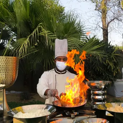 There is nothing more captivating than the theater of live cooking. Here, one of our chefs creates a dish with a dramatic flair of fire, adding an element of excitement and spectacle to the dining experience.