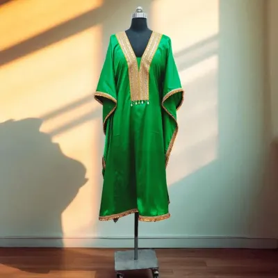 This stunning emerald green kaftan shines in soft satin, with a beautiful gold embroidered neckline. It's a comfortable yet luxurious choice for any festive celebration.