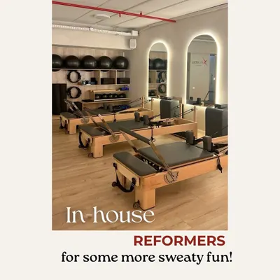 A look at our in-house reformers, all lined up and ready for some sweaty fun. We manufacture our own equipment to ensure it's sturdy, smooth, and supportive.