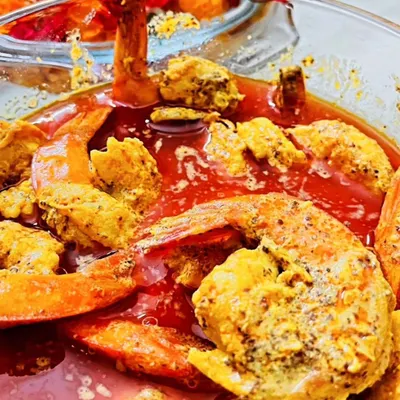 This is my Shorshe Chingri, prawns cooked in a pungent mustard gravy with a secret ingredient that my family loves. It’s a dish that’s both fiery and comforting, best enjoyed with a plate of hot steamed rice.