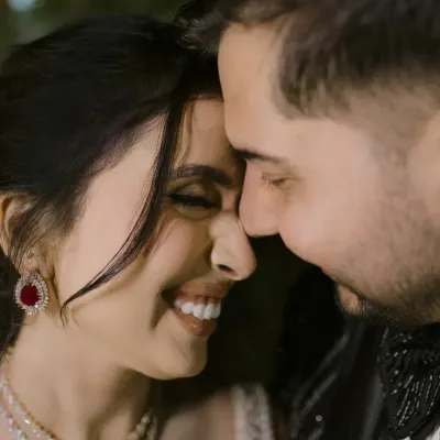 A close-up that speaks of pure happiness. This is the energy of a Sangeet night, a celebration of love where every smile shines brighter than the lights.