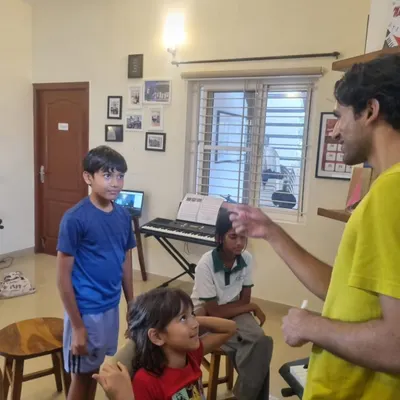 An instructor guiding students through a music concept. These small group interactions are key to ensuring every child gets the attention they need to understand and grow.