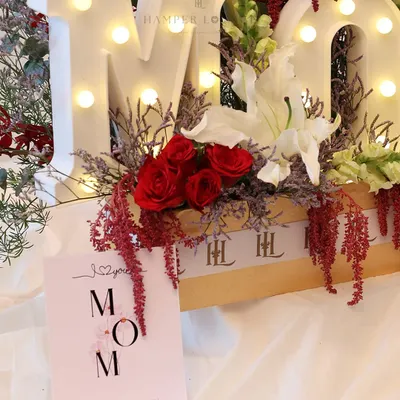 This Mother’s Day, I designed the "MOM" hamper to be the heart of the celebration. The light-up letters are surrounded by a lush arrangement of red roses, white lilies, and other exotic florals, creating a truly show-stopping gift.