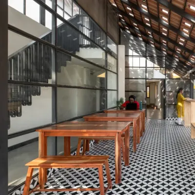 For the Earthen Spirit co-living project, I redesigned the terrace into an airy cafeteria and gym, featuring a Mangalore clay tile roof with glass inserts for dynamic light.