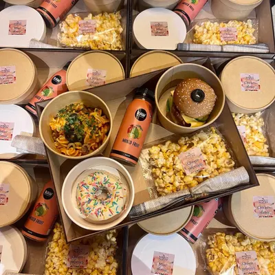 An inside look at one of my custom food boxes for a kid's birthday party. This box contains a balanced and fun meal: fusilli arrabbiata pasta, a mini slider, cheese popcorn, a sprinkle donut, and a mixed fruit juice.