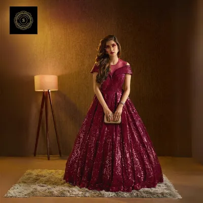 Steal the spotlight in this magnificent wine-colored sequin gown. The full, glittering skirt and flattering silhouette make it the perfect choice for a reception or gala event.