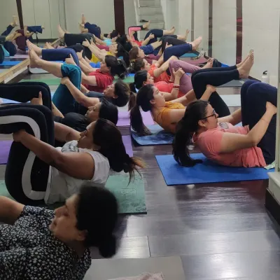 A typical session at my center, where we focus on result-oriented yoga. Here, my clients are engaged in core-strengthening exercises that are key for inch loss and building a strong, toned midsection.