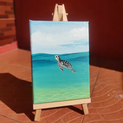 This mini acrylic painting of a sea turtle was a joy to create. The blending of the water colors and the details on the turtle shell make it a peaceful piece of ocean art.