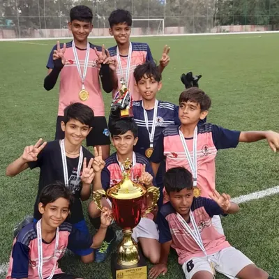That winning feeling! Our players proudly lift the Unity Football Tournament trophy after a hard fought competition. This victory is a testament to their dedication.