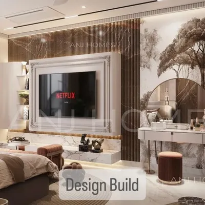 This master bedroom was designed with modern detailing. It features fluted marble walls, a custom TV unit, and a dedicated vanity with a statement mirror, blending function with high-end finishes.