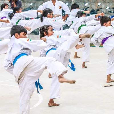 A group of our young students practicing front kicks in unison. This high-energy shot captures the discipline and enthusiasm of our kids' karate classes.