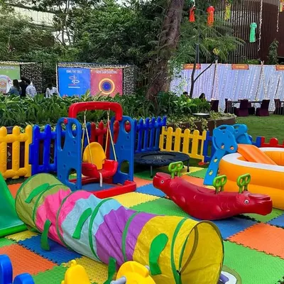 A full view of a large outdoor play zone rental. This shows how all the different pieces like the slide, swing, and ball pit fit together to create a complete park for kids.
