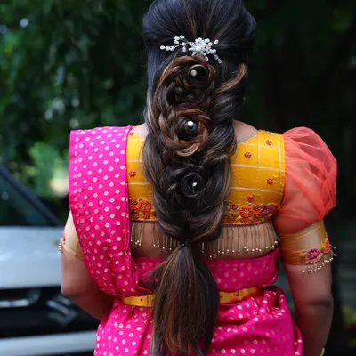 A back view of this stunningly intricate rose braid. This advanced hairstyle is a work of art and adds a modern, romantic touch to a traditional outfit.