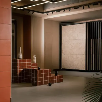 This corner of the Trove showroom was designed for discovery. The stepped, tiled platform serves as both seating and a real-world application of the product, while the large sliding display racks allow customers to focus on each tile collection without distraction.