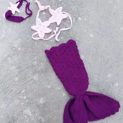 Your baby's first mermaid moment. This three-piece set includes a purple mermaid tail, a starfish-style bikini top, and a matching starfish headband. It's one of my favorite fantasy outfits to create.