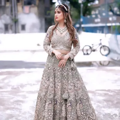 This heavily embroidered pastel green lehenga is a showstopper. The intricate peacock motifs and full-coverage sequin work make it a luxurious choice for a bride or bridesmaid.