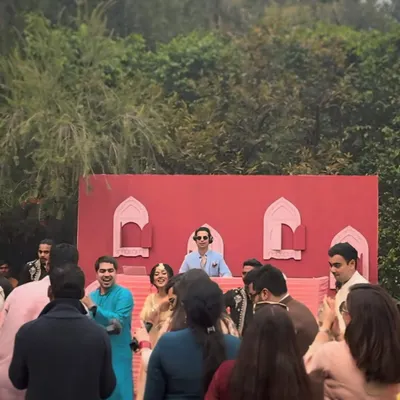 A beautiful daytime mehndi with a unique red and pink decor. I'm in the zone, playing tunes that get everyone twirling and smiling in the afternoon sun.