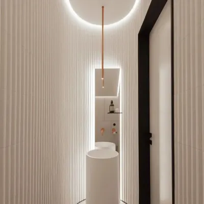 Even a small space like a washroom deserves thoughtful design. This concept features curved, fluted walls, a minimalist pedestal sink, and dramatic backlighting to create a sleek and modern look.