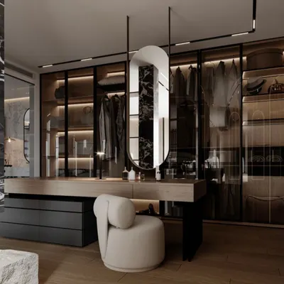 This is where your wardrobe and vanity become one cohesive space. This design features a sleek vanity table integrated with glass-fronted, internally lit wardrobes, creating a sophisticated and organized dressing room.