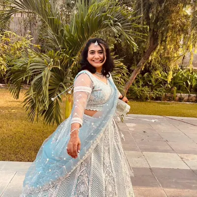 A happy client twirling in our popular powder blue lehenga. This rental is perfect for a daytime event or a sangeet night.