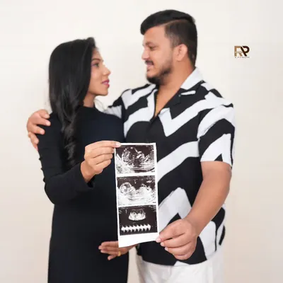 The first hello. We love incorporating your baby's first pictures into the shoot. This couple's portrait, featuring their ultrasound scan, is a deeply personal and emotional keepsake.