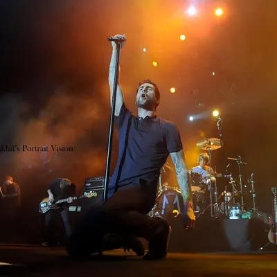 Adam Levine of Maroon 5 during a powerful moment on stage. I captured this low-angle shot to emphasize his connection with the music and the energy he pours into his performance.