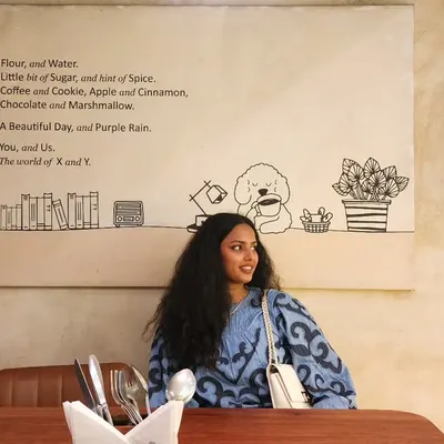A casual cafe outing. I'm wearing a comfortable printed blue top that's stylish yet relaxed. This is a great example of an easy, everyday look that I can help you build from your own closet.