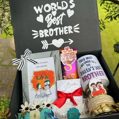 A "World's Best Brother" hamper that truly lives up to its name. This large gift box is filled with a custom mug, photo frame, chocolates, a personalized rakhi, and other treats.