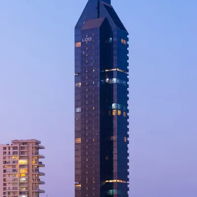 A view of the Lodha Altamount tower at dusk, where its distinctive silhouette stands out against the South Bombay skyline. The 40-story structure is a testament to our design philosophy of creating simple yet elegant architectural statements.