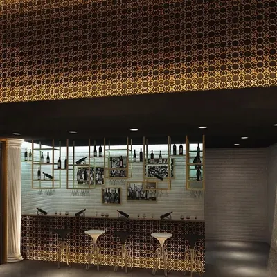 A concept for a sophisticated smoke lounge and bar area. The design features a dramatic gold patterned ceiling, custom bottle displays, and elegant bar seating.