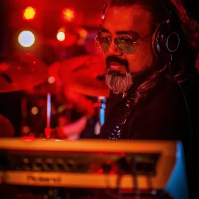 Our keyboardist, deep in the zone, surrounded by the warm glow of the stage lights.