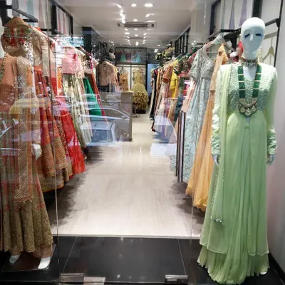 A view from the entrance of my store, showcasing mannequins dressed in the latest styles and racks of colorful designer wear waiting to be explored.