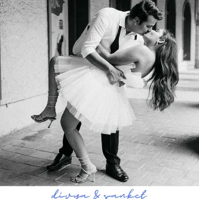 A classic Hollywood-style dip and kiss. This black and white shot, with her beautiful tulle dress and his effortless style, feels like a moment straight out of a timeless romantic movie.