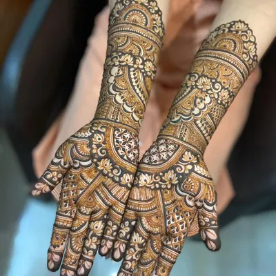 A stunningly detailed bridal mehendi with a mix of floral, paisley, and geometric patterns. The fine linework and shading create a design with incredible depth.