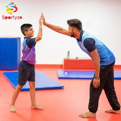 A high five for a job well done. Our coaches celebrate every small win, providing constant encouragement and positive reinforcement to build confidence alongside physical strength in our young gymnasts.